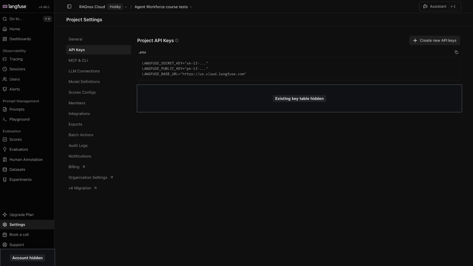 Langfuse Project Settings, API Keys tab. A .env block shows placeholder values sk-lf-... and pk-lf-... with the US base URL, and a Create new API keys button sits at the top right. The existing key table is masked.